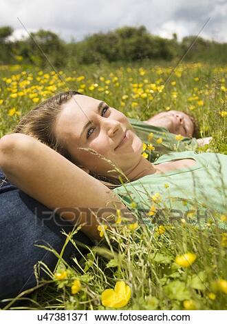 Couple Lying In Meadow View Large Photo Image Stock Image - Couple Lying In Meadow. Fotosearch