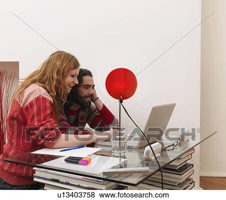 Couple on laptop, using credit card View Large Photo Image Stock Photo - Couple on laptop, using credit card. Fotosearch