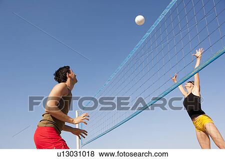 Couple Playing Beach Volleyball View Large Photo Image Stock Photo - Couple Playing Beach Volleyball. Fotosearch
