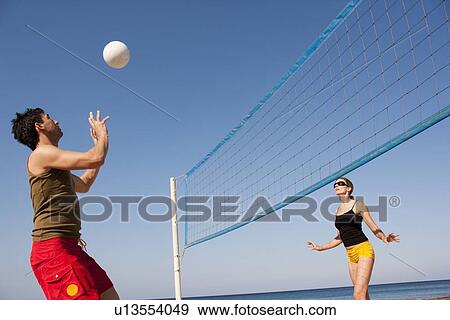 Couple Playing Beach Volleyball View Large Photo Image Stock Photo - Couple Playing Beach Volleyball. Fotosearch