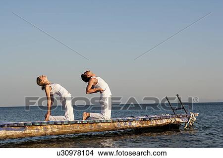 Couple Practicing Yoga View Large Photo Image Picture - Couple Practicing Yoga. Fotosearch