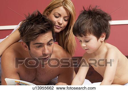 couple reading boy a story in bed View Large Photo Image Stock Image - couple reading boy a story in bed. Fotosearch