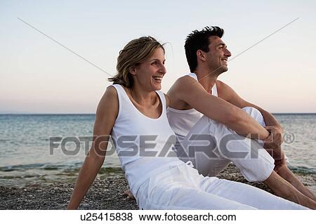Stock Photo - Couple Relaxing At Beach. Fotosearch