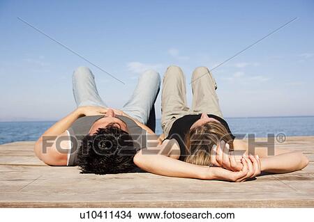 Couple Relaxing On Pier View Large Photo Image Picture - Couple Relaxing On Pier. Fotosearch