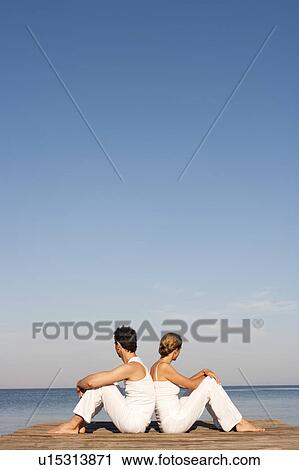 Couple Sitting On Pier View Large Photo Image Stock Image - Couple Sitting On Pier. Fotosearch