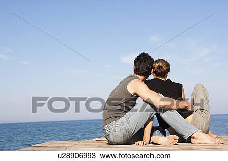 Couple Sitting On Pier View Large Photo Image Stock Image - Couple Sitting On Pier. Fotosearch
