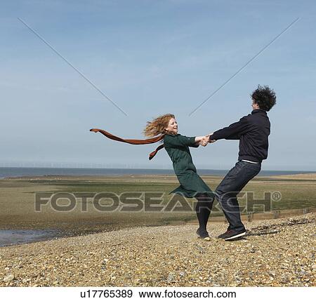 Stock Photo - Couple spinning each other around. Fotosearch