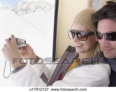 Stock Photo - couple taking picture of themselves. Fotosearch