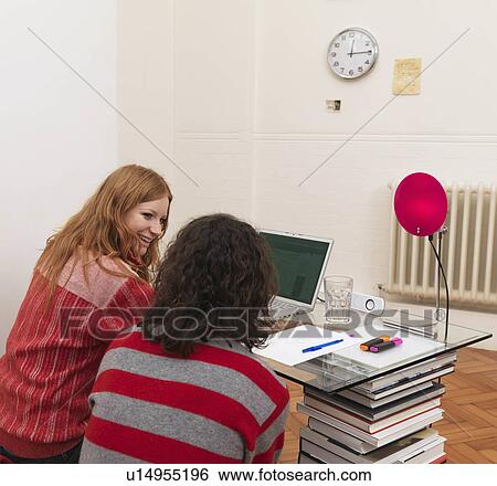 Couple using laptop, woman smiling View Large Photo Image Stock Photograph - Couple using laptop, woman smiling. Fotosearch
