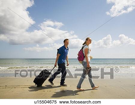 Couple walking on beach With Case View Large Photo Image Stock Photography - Couple walking on beach With Case. Fotosearch