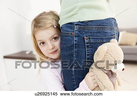 daughter hiding behind mother View Large Photo Image Stock Photography - daughter hiding behind mother. Fotosearch