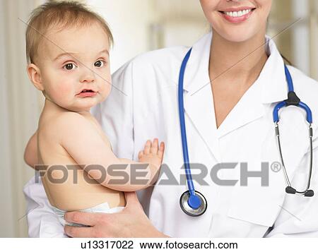 Doctor carrying baby boy View Large Photo Image Stock Image - Doctor carrying baby boy. Fotosearch