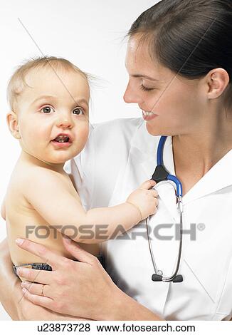 Doctor carrying baby boy View Large Photo Image Stock Photo - Doctor carrying baby boy. Fotosearch