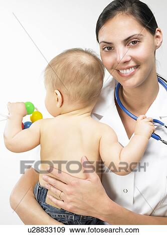 Doctor carrying baby boy View Large Photo Image Stock Photo - Doctor carrying baby boy. Fotosearch