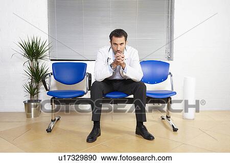 Stock Image - Doctor in waiting room. Fotosearch