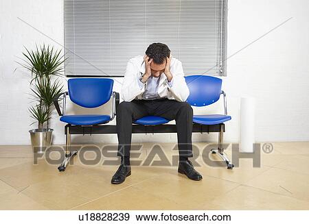 Stock Photo - Doctor with head in his hands. Fotosearch