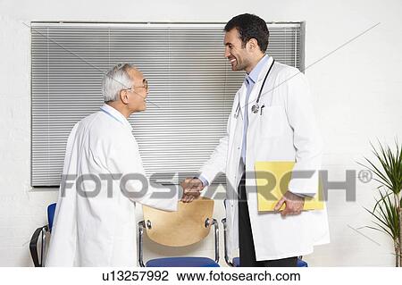 Stock Image - Doctors in waiting room. Fotosearch