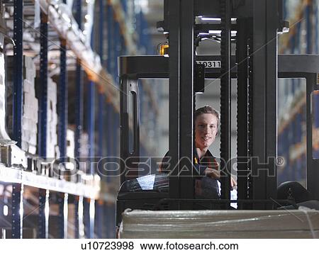 Stock Photo - Driver In Forklift In Warehouse. Fotosearch
