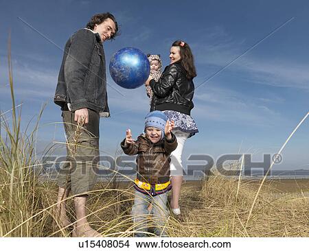 family at beach playing with ball View Large Photo Image Picture - family at beach playing with ball. Fotosearch