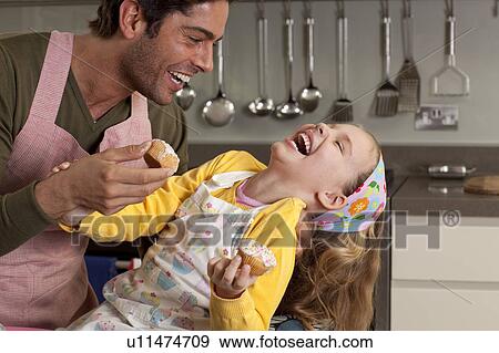 Stock Photo - father and daughter cooking. Fotosearch