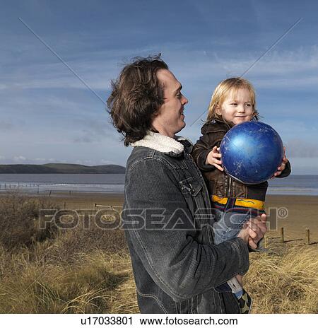 father and son at beach playing with ball View Large Photo Image Stock Image - father and son at beach playing with ball. Fotosearch