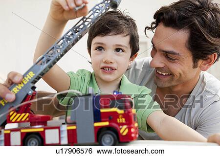 father and son playing View Large Photo Image Stock Photograph - father and son playing. Fotosearch