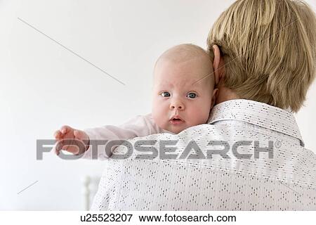 Stock Photo - father carrying baby on shoulder. Fotosearch