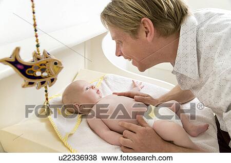 father changing baby's nappy View Large Photo Image Stock Photo - father changing baby's nappy. Fotosearch