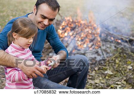 father helping daughter to carve stick View Large Photo Image Stock Image - father helping daughter to carve stick. Fotosearch