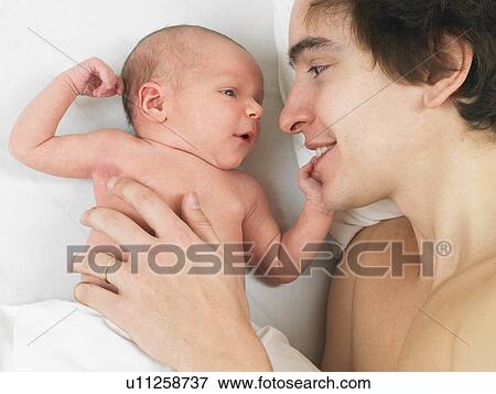 Father playing with his her baby View Large Photo Image Stock Photo - Father playing with his her baby. Fotosearch