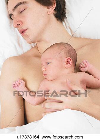 Father sleeping with his her baby View Large Photo Image Picture - Father sleeping with his her baby. Fotosearch