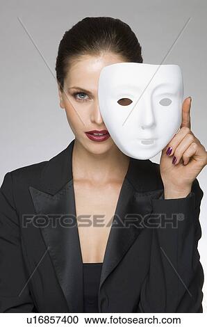 Stock Image - Female as business woman with mask. Fotosearch