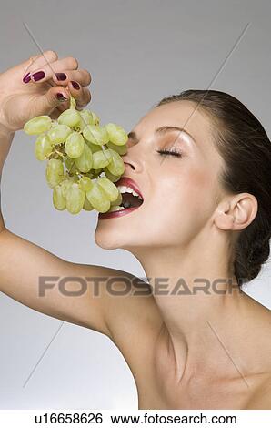 female beauty eating grapes View Large Photo Image Stock Photograph - female beauty eating grapes. Fotosearch