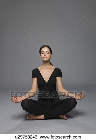 Stock Image - female beauty in catsuit yoga position. Fotosearch