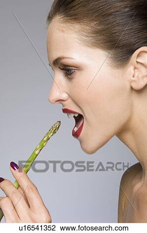 Female beauty model eating asparagus View Large Photo Image Stock Image - Female beauty model eating asparagus. Fotosearch