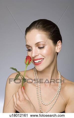 Female beauty model smelling rose View Large Photo Image Stock Image - Female beauty model smelling rose. Fotosearch