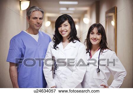 Stock Photo - Female Doctors and male surgeon smiling. Fotosearch