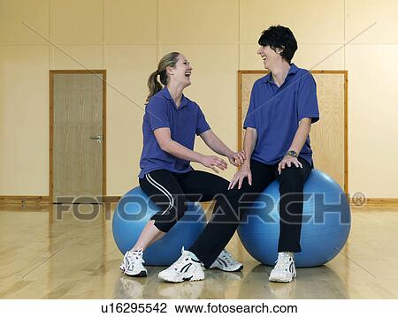 female gym instructors relaxing on balls View Large Photo Image Stock Image - female gym instructors relaxing on balls. Fotosearch
