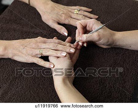 Stock Photograph - female hands receiving manicure. Fotosearch