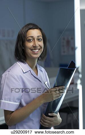 Female nurse holding x-rays View Large Photo Image Stock Photo - Female nurse holding x-rays. Fotosearch