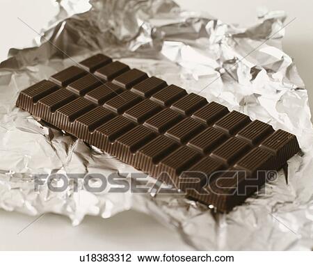 Food - bar of dark chocolate on foil View Large Photo Image Stock Image - Food - bar of dark chocolate on foil. Fotosearch