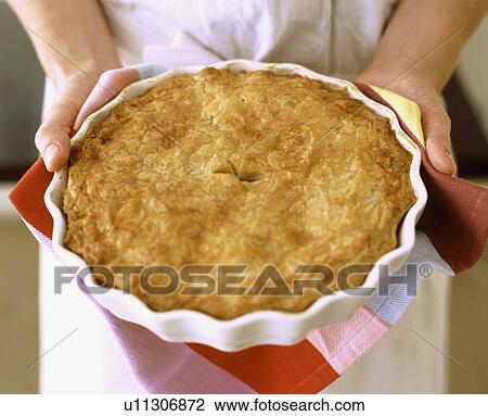 Stock Image - Food - hands holding fresh pie. Fotosearch