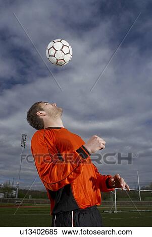 Stock Photography - footballer heading a ball to himself. Fotosearch