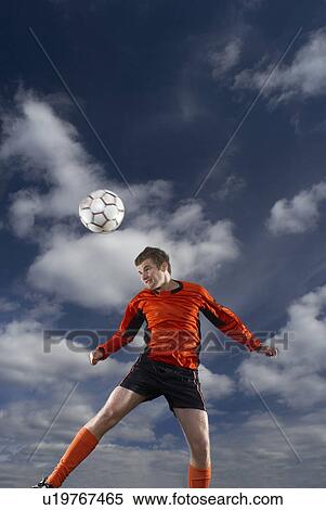 Stock Photography - footballer heading ball. Fotosearch