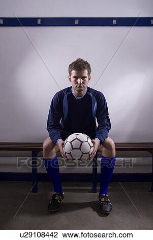 Stock Image - footballer in changing room. Fotosearch