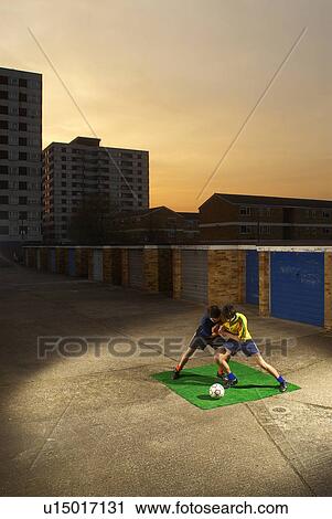 footballers playing by garages View Large Photo Image Stock Image - footballers playing by garages. Fotosearch
