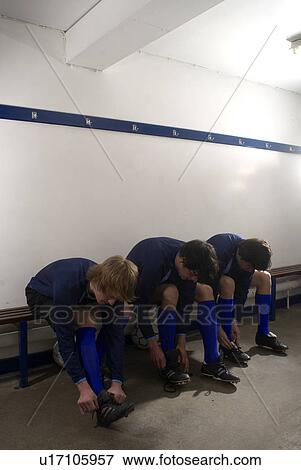 footballers putting boots on View Large Photo Image Stock Photo - footballers putting boots on. Fotosearch