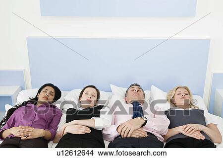 Picture - Four business people in a bed. Fotosearch