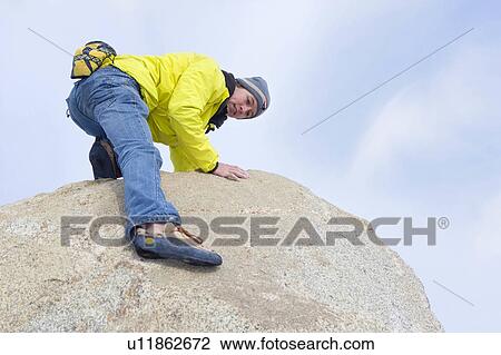 Free climber descending boulder View Large Photo Image Stock Image - Free climber descending boulder. Fotosearch