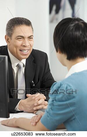 Stock Image - Friendly customer service. Fotosearch